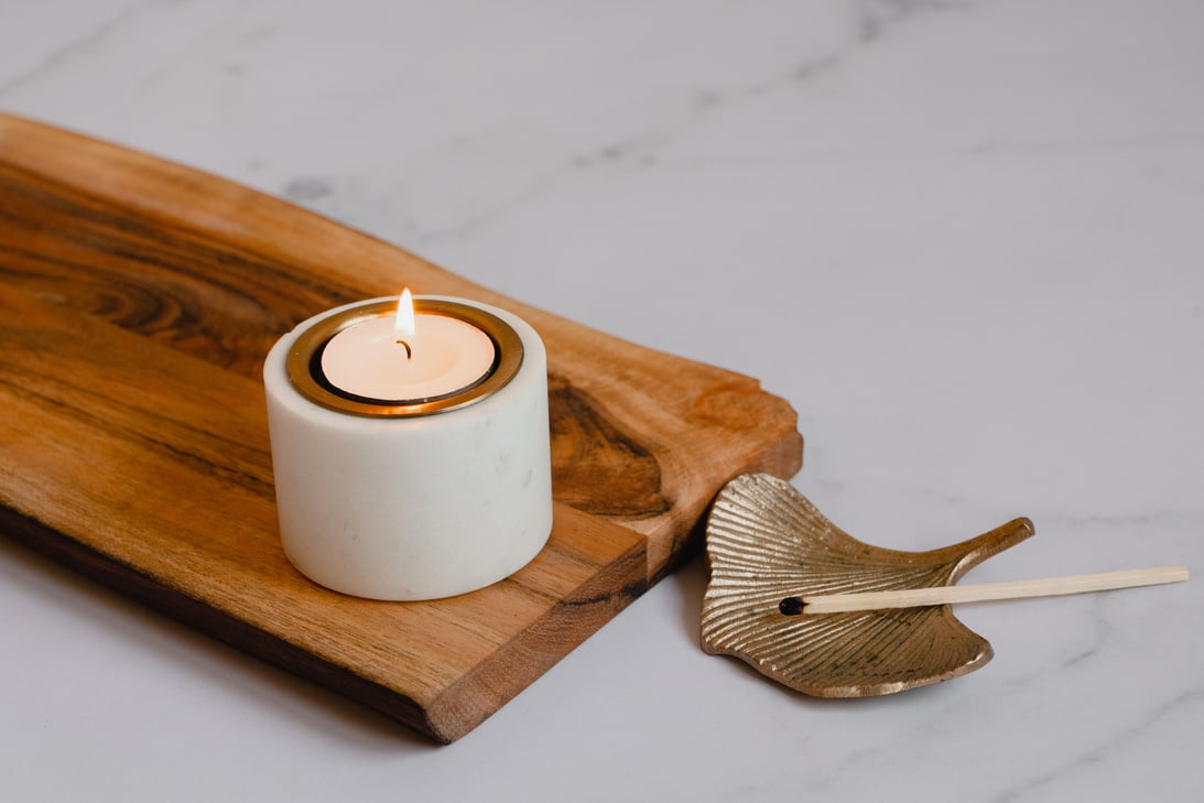 Lighted Candle on Wooden Board