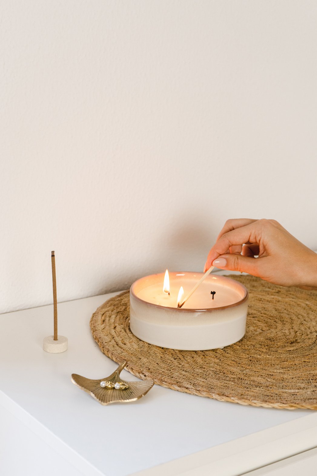 Woman Lighting a Candle